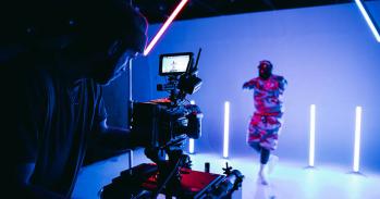 Videographer in studio with a model